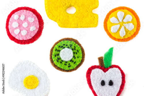 Handmade toy in the form of fruits and food made of felt . Close-up of crafts with embroidery