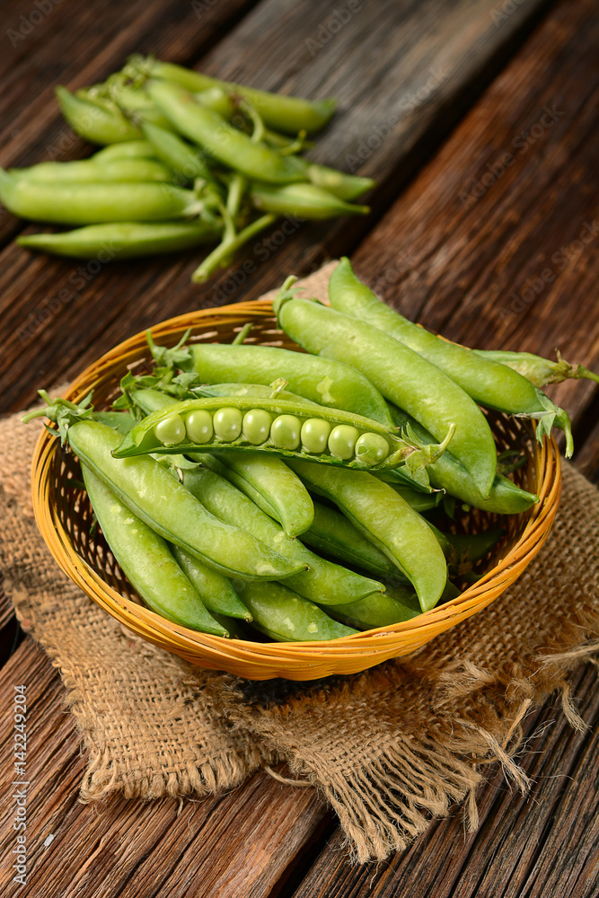 fresh green peas on the wooden table fresh green peas on the wooden table