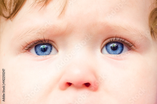 Baby face with blue eyes, close-up