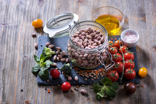 Cooking ingredients with vegetables, lentils, rice and beans in bowl, vegetarian and vegan food concept, copy space healthy food background