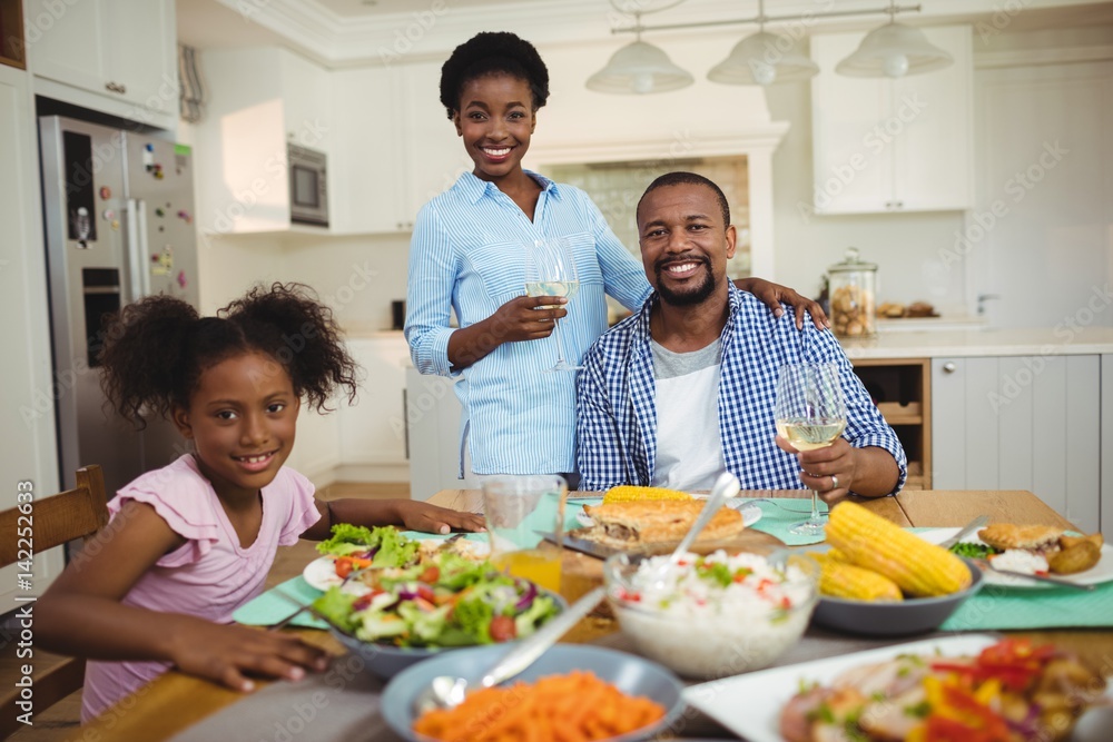 Portrait of family having meal on dinning table at home Portrait of family having meal on dinning table at home
