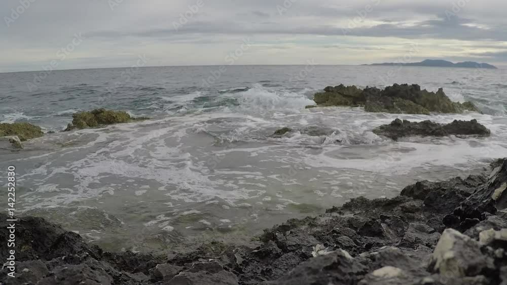 Beautiful slow motion sea crash into beach rocks. Beautiful slow motion sea crash into beach rocks.