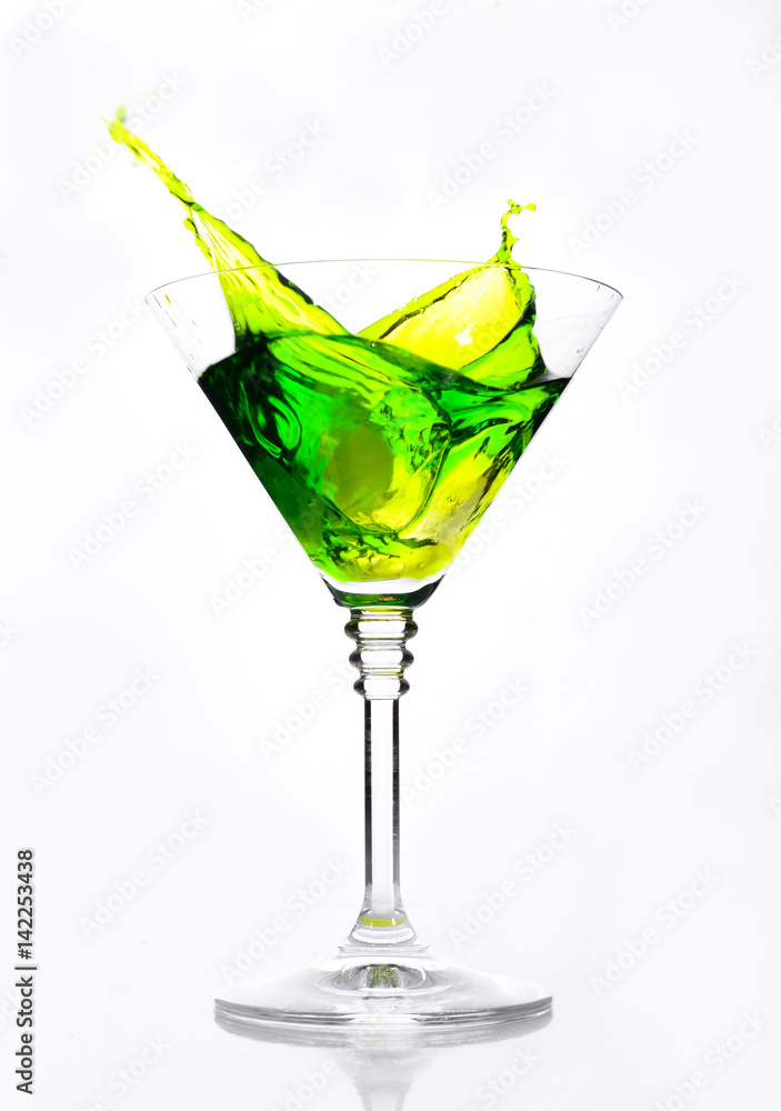 A glass with green cocktail on a white background. A glass with green cocktail on a white background.