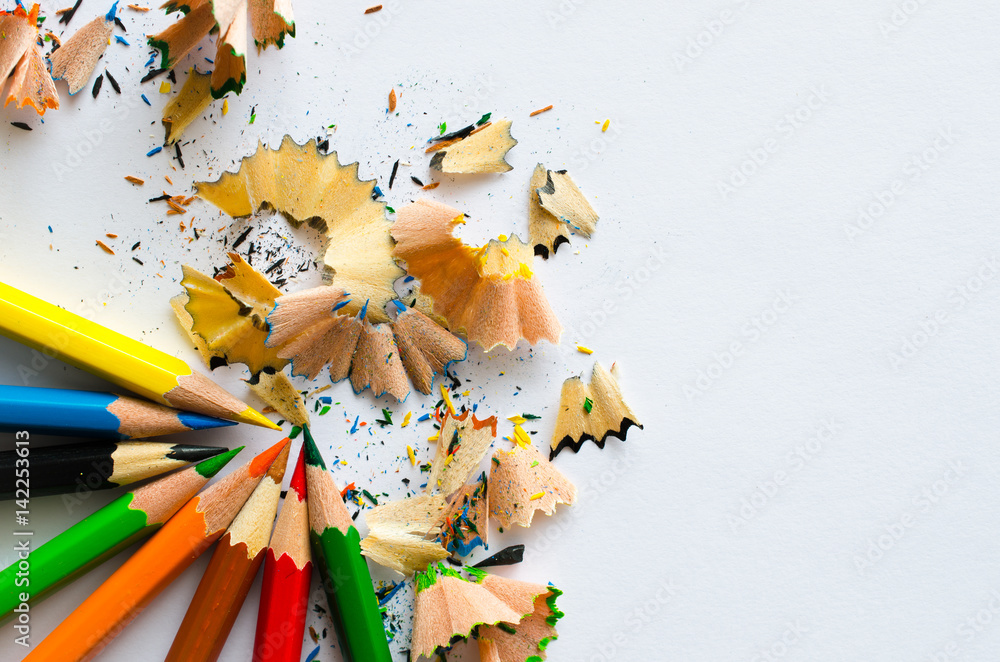 colored pencils lying on a sheet of white paper colored pencils lying on a sheet of white paper