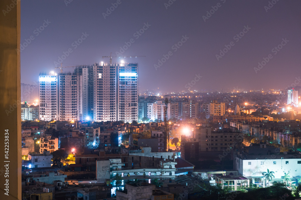 Fototapeta premium Under construction Apartment buildings in Noida Delhi. Many such buildings have come up to support the huge rise in people living