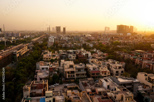 Noida cityscape at dusk with the under construction buildings and golden sunset light