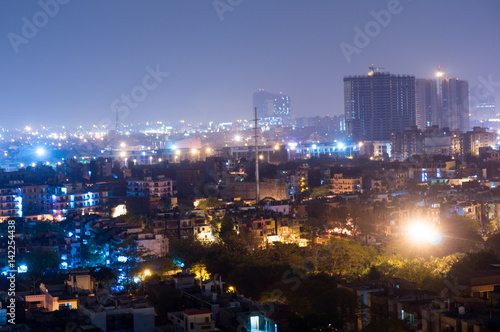 Cityscape of Noida Delhi at night with lights and under construction buildings