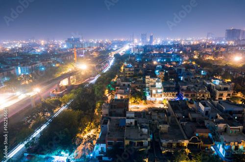 Cityscape of Noida Delhi at night with lights and under construction buildings