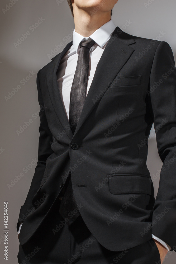 A man in a black suit and a white shirt A man in a black suit and a white shirt