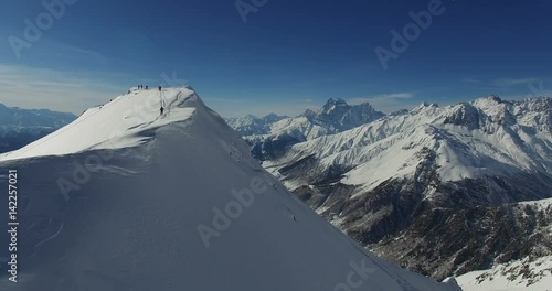 Rise of people to the top of the mountain, climbers. Aerial video 4k