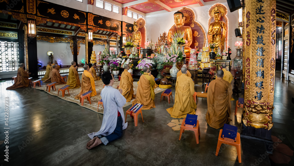 Ho Chi Minh City, Vietnam - November 27, 2015 - People praying in the buddhist temple Vinh Nghiem