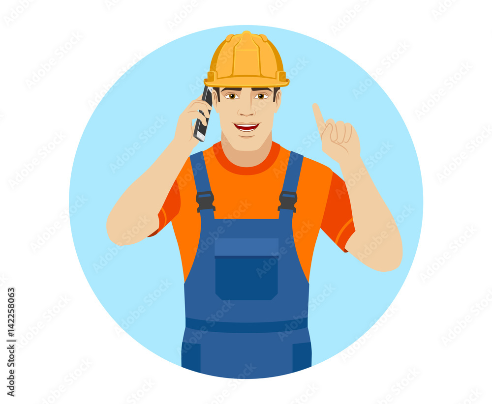 Builder talking on the mobile phone and pointing up Builder talking on the mobile phone and pointing up