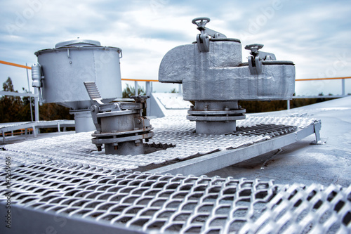 Large steel safety valve on the roof of the tank with gasoline