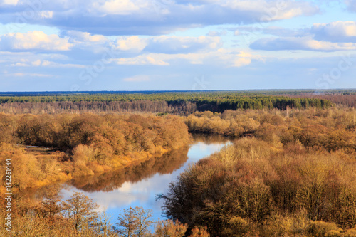 Typical landscape of Central Russia in the spring. The river among the trees on the plain.