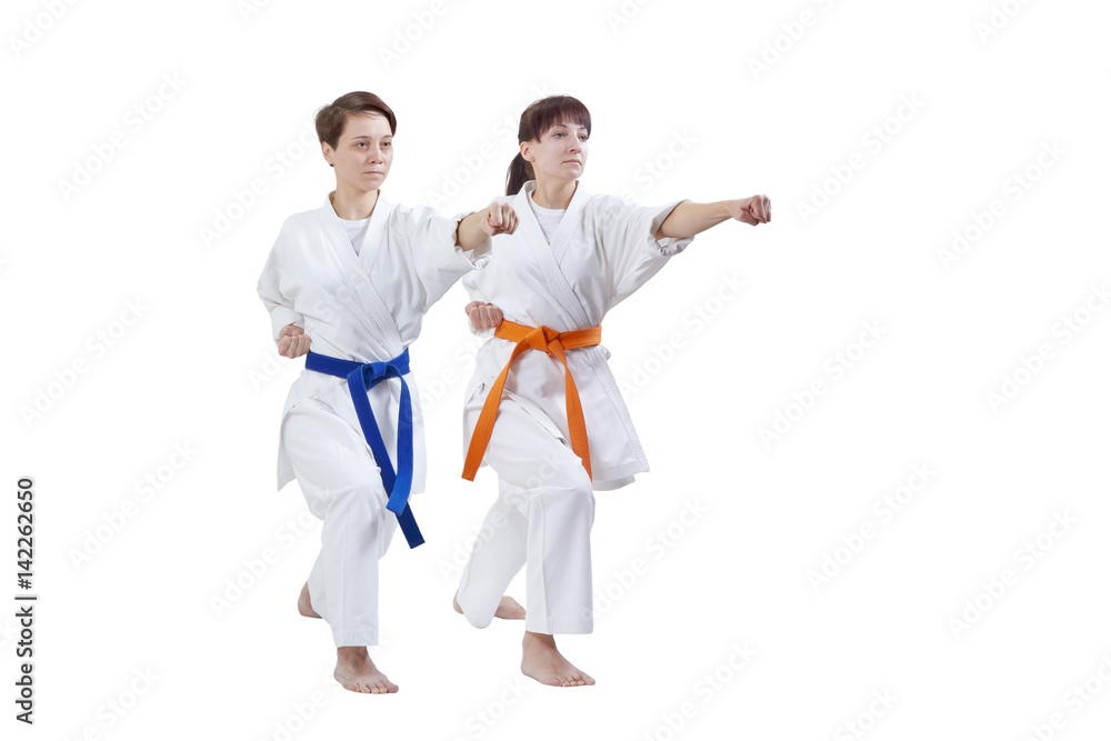 Girls in karategi are training punch hand