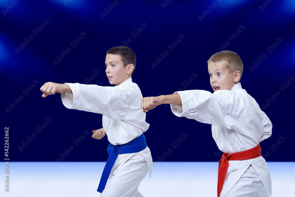 On a dark blue background athletes are beating blow a hand On a dark blue background athletes are beating blow a hand