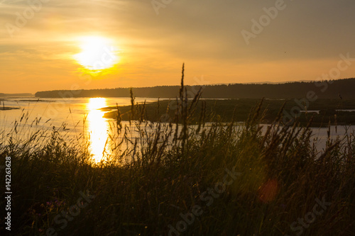 Evening on the river. Sunset and reflection