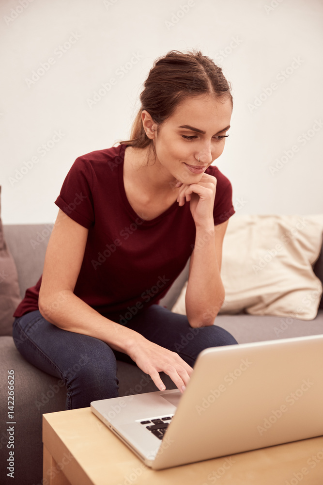 Fototapeta premium Cute young woman relaxing with laptop