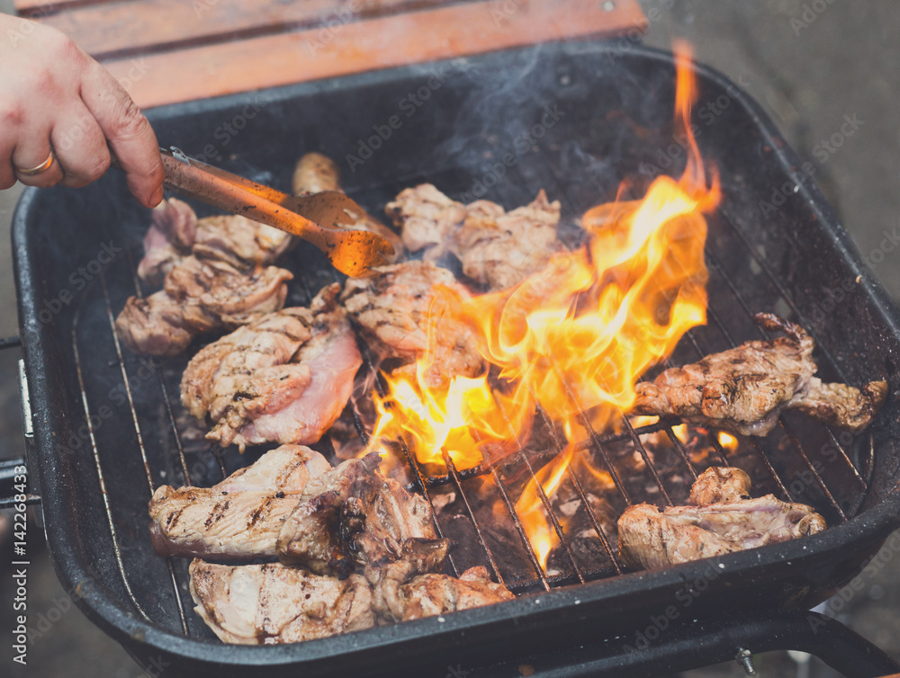 Grill steaks on metal grate with flame, barbecue Grill steaks on metal grate with flame, barbecue