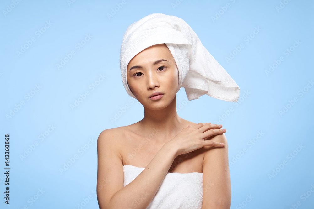 beautiful woman with bare shoulders, white towel on her head beautiful woman with bare shoulders, white towel on her head