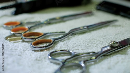 barber takes scissors from a full tool board slow motion good