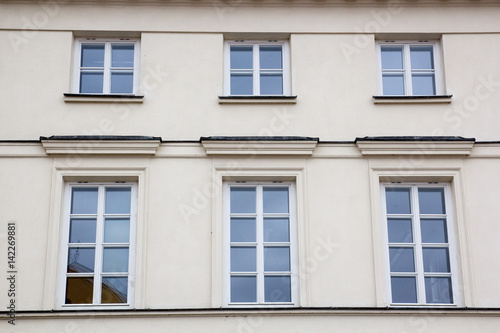 Six vintage design windows on the facade of the old house