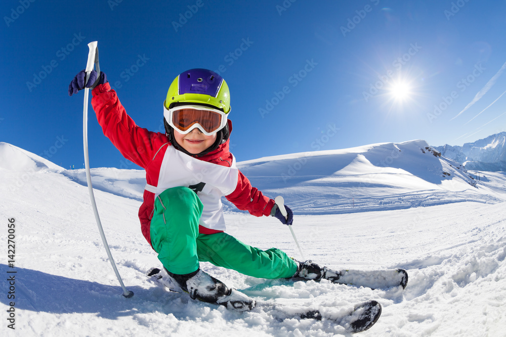 Little skier having fun at sunny snowy day - obrazy, fototapety, plakaty 