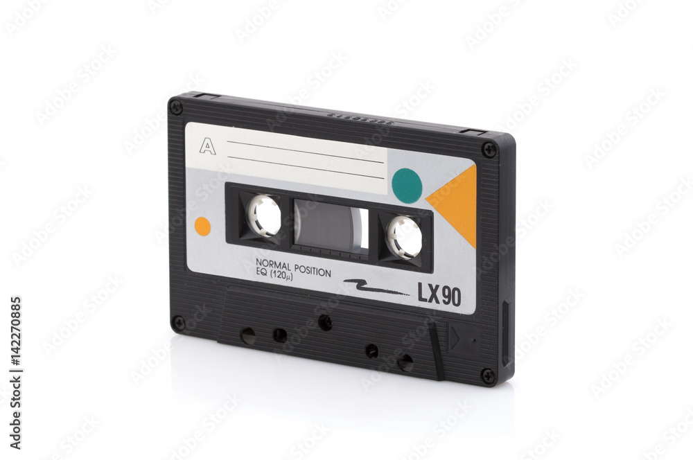 Vintage black compact cassette on white background