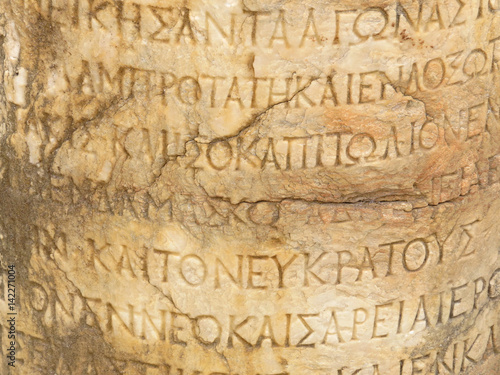 Ancient marble Hellenistic text column on the ruins of the ancient city of Side photo