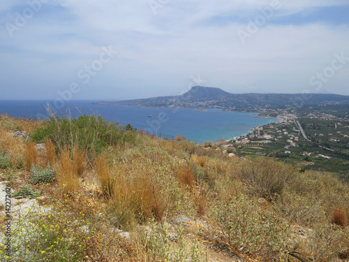 Grass and bushes on a hill on a background of coast of the island of Crete  Greece  Mediterranean
