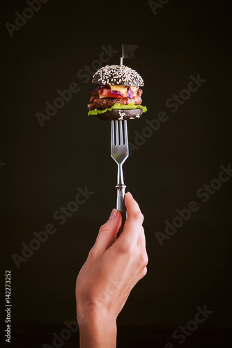 Obraz na płótnie Black mini burger on the fork