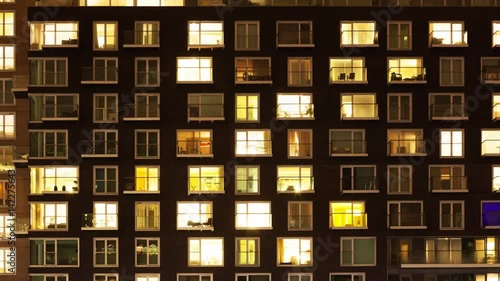 Time-lapse of the exterior of a modern apartment block at night