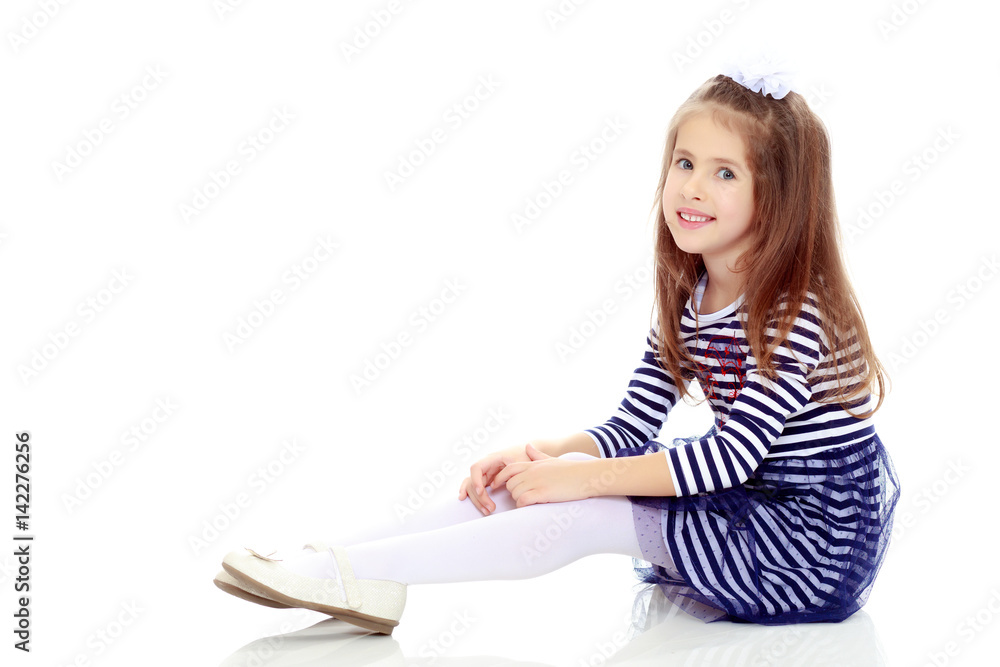 Little girl sitting on the floor. Little girl sitting on the floor.