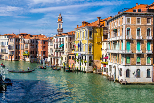 View of the canal with boats and gondolas in Venice, Italy. Venice is a popular tourist destination of Europe