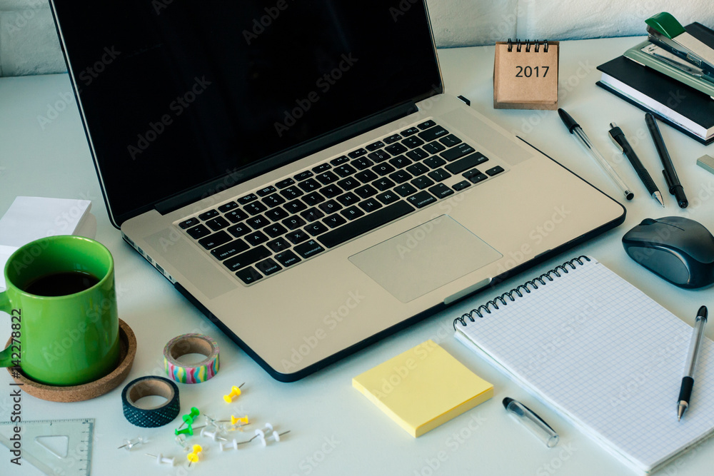Workspace with laptop notebook stick notes scotch coffee cup on white background. Template mock up place for text Office table desk. Freelancer working place area. Working at home or online concept Workspace with laptop notebook stick notes scotch coffee cup on white background. Template mock up place for text Office table desk. Freelancer working place area. Working at home or online concept
