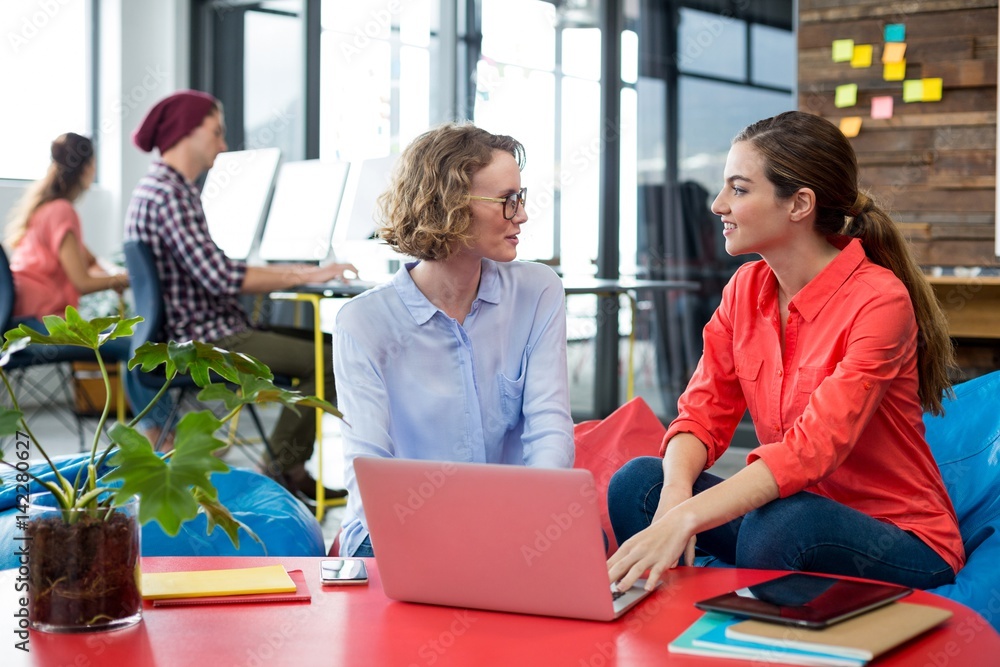 Business executives discussing with each other Business executives discussing with each other