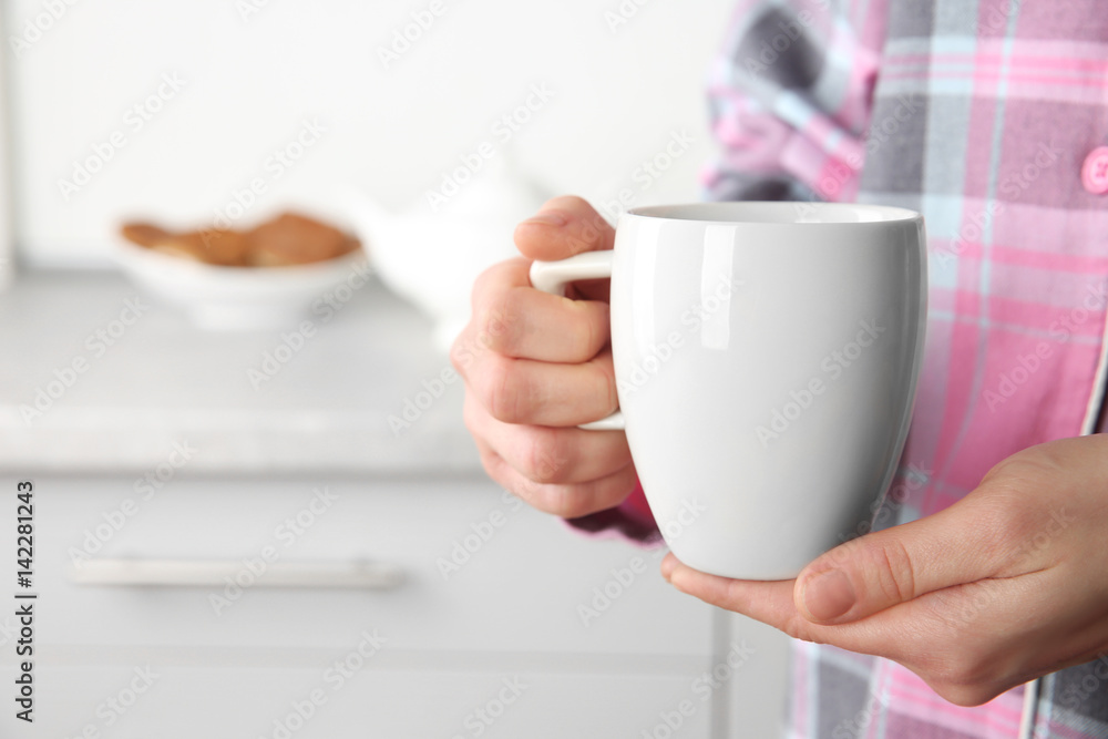 Closeup view of woman holding cup Closeup view of woman holding cup