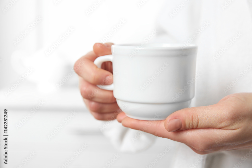 Closeup view of woman holding cup Closeup view of woman holding cup