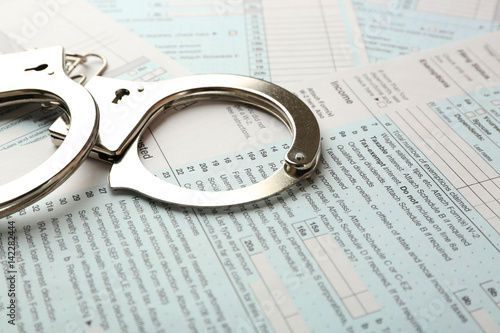 Handcuffs on income tax return form background