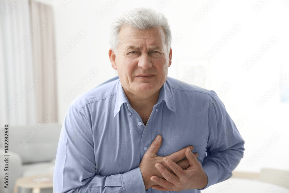 Man with chest pain suffering from heart attack in office Man with chest pain suffering from heart attack in office