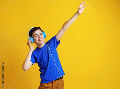 Teenager with headphones li...