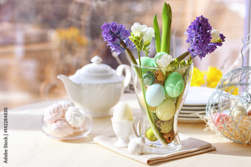 Beautiful Easter pastel decorations with table setting on blurred background