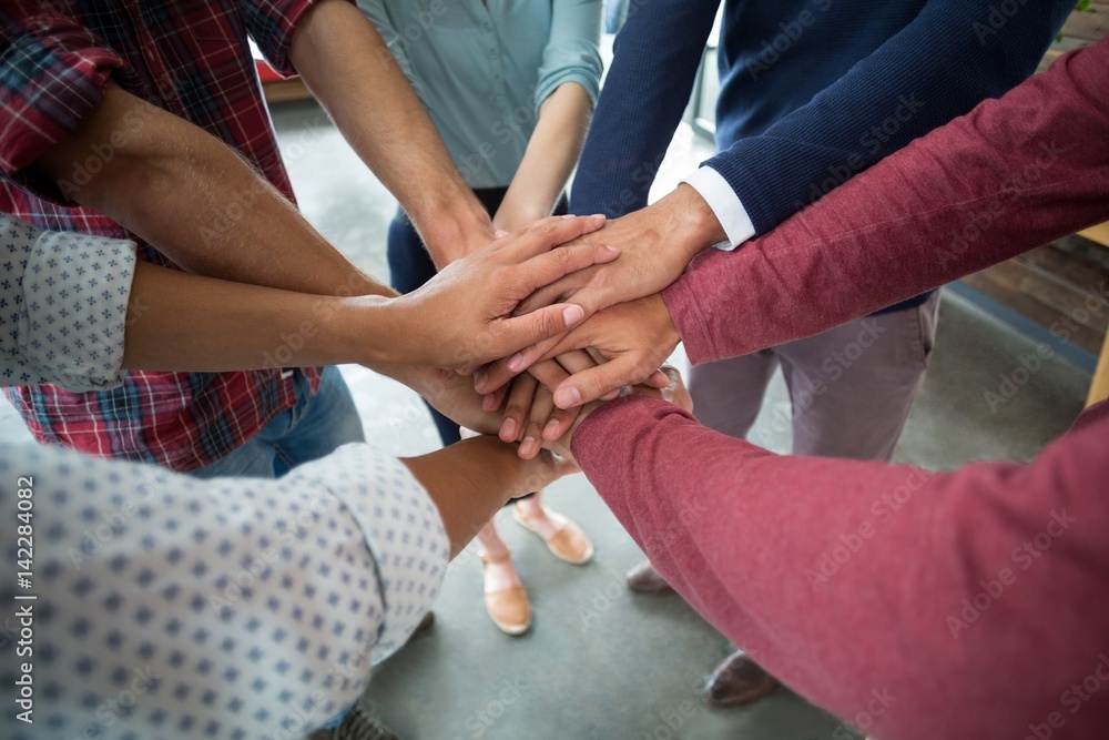 Team of businesspeople forming hand stack Team of businesspeople forming hand stack