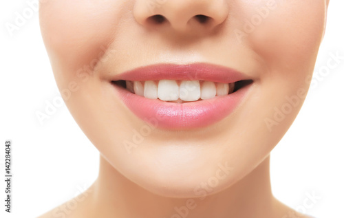 Smiling young woman on whit...
