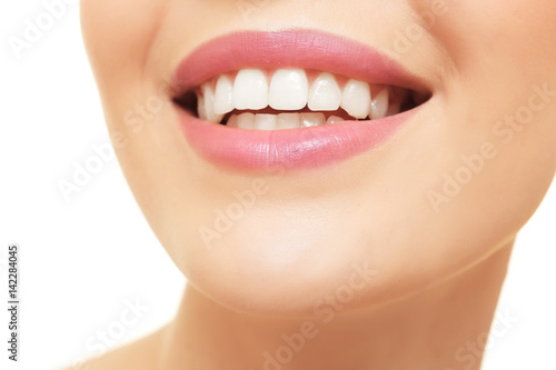 Smiling young woman on white background, closeup