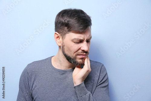 Handsome man suffering from...