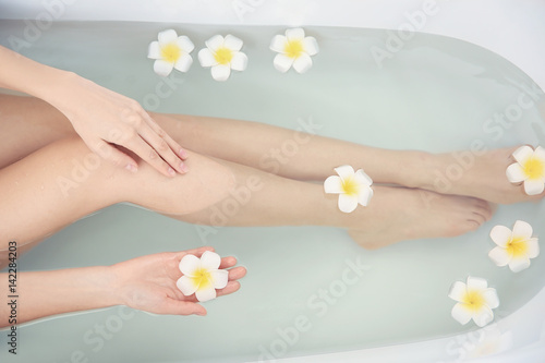 Beautiful young woman taking bath at home