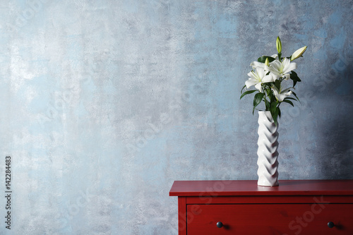 Fototapeta Naklejka Na Ścianę i Meble -  Beautiful white lilies in vase on table