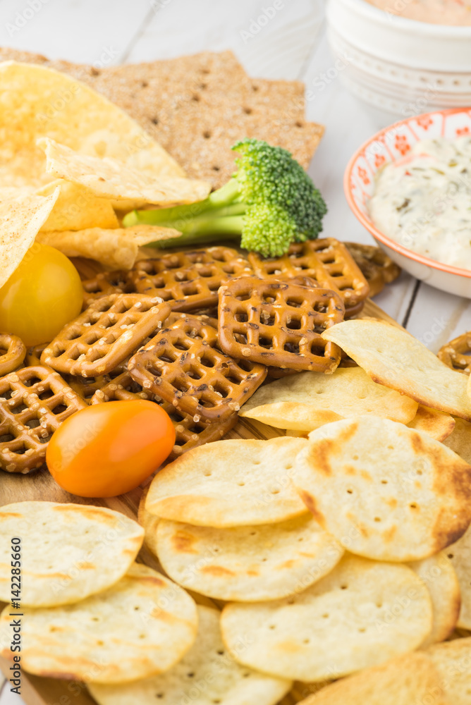 Variety of snacks with dips and salsa.