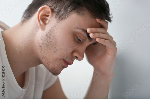 Handsome depressed man at h...